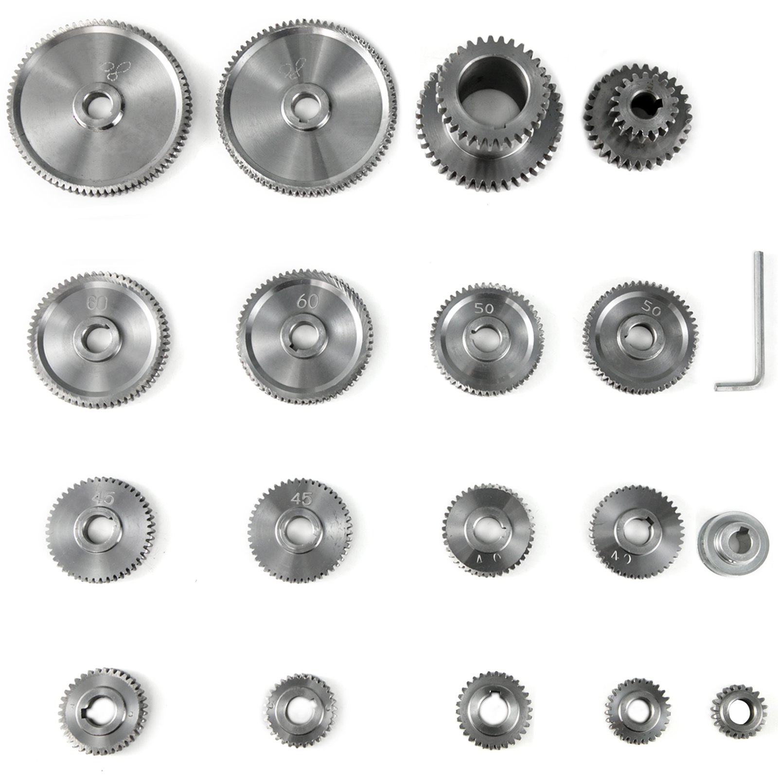 Juego de engranajes para mini torno VEVOR dispuestos en filas con una llave Allen.