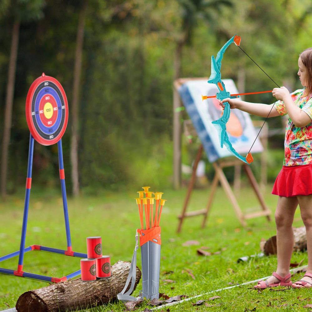 Niño jugando al aire libre con el arco y la flecha para niños VEVOR, apuntando a un tablero de objetivos, flechas en un carcaj.