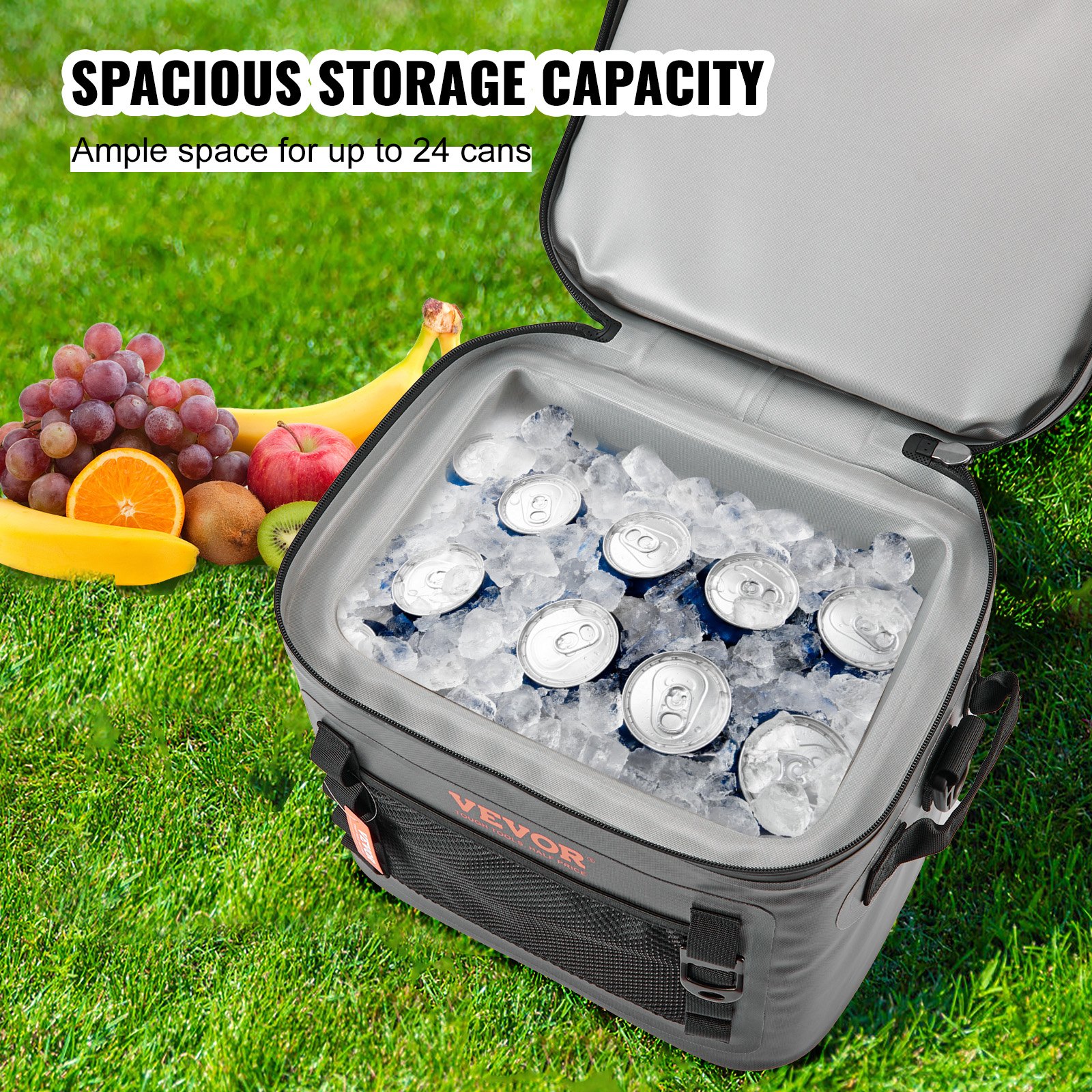 Bolsa térmica suave VEVOR llena de hielo y latas, rodeada de frutas frescas sobre césped.