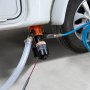 Bomba maceradora VEVOR rv conectada a la salida de desechos de un vehículo recreativo con mangueras y cableado adjuntos.