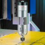Motor de husillo CNC VEVOR montado en una máquina con una superficie de trabajo perforada amarilla.