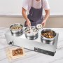 Calentador de sopa eléctrico VEVOR con tres ollas de acero inoxidable sobre una encimera de cocina con varios platos al fondo.