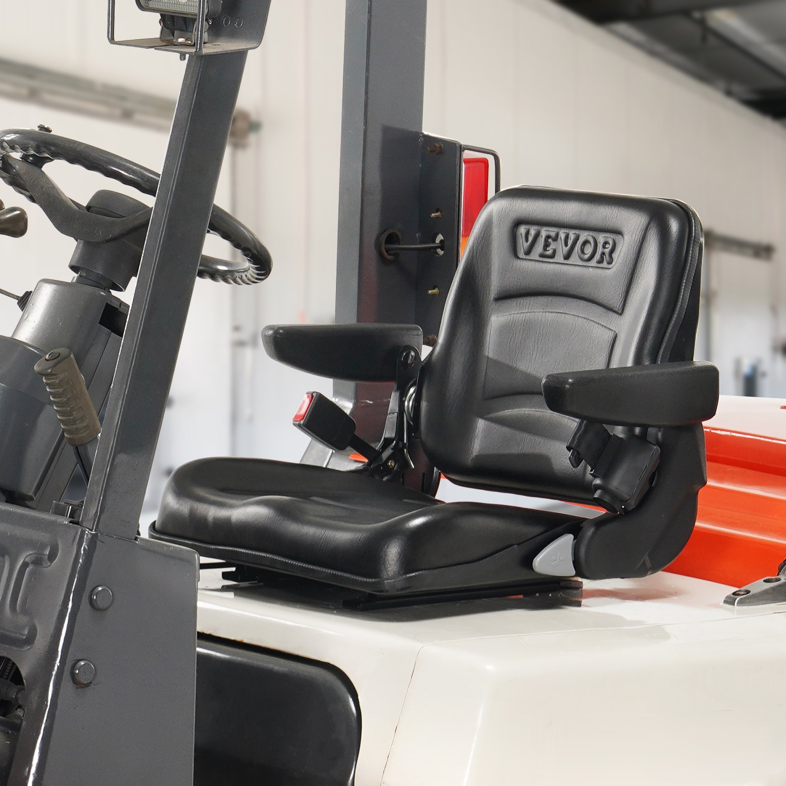 Asiento de carretilla elevadora VEVOR en carretilla elevadora con reposabrazos y cinturón de seguridad en un entorno de almacén.