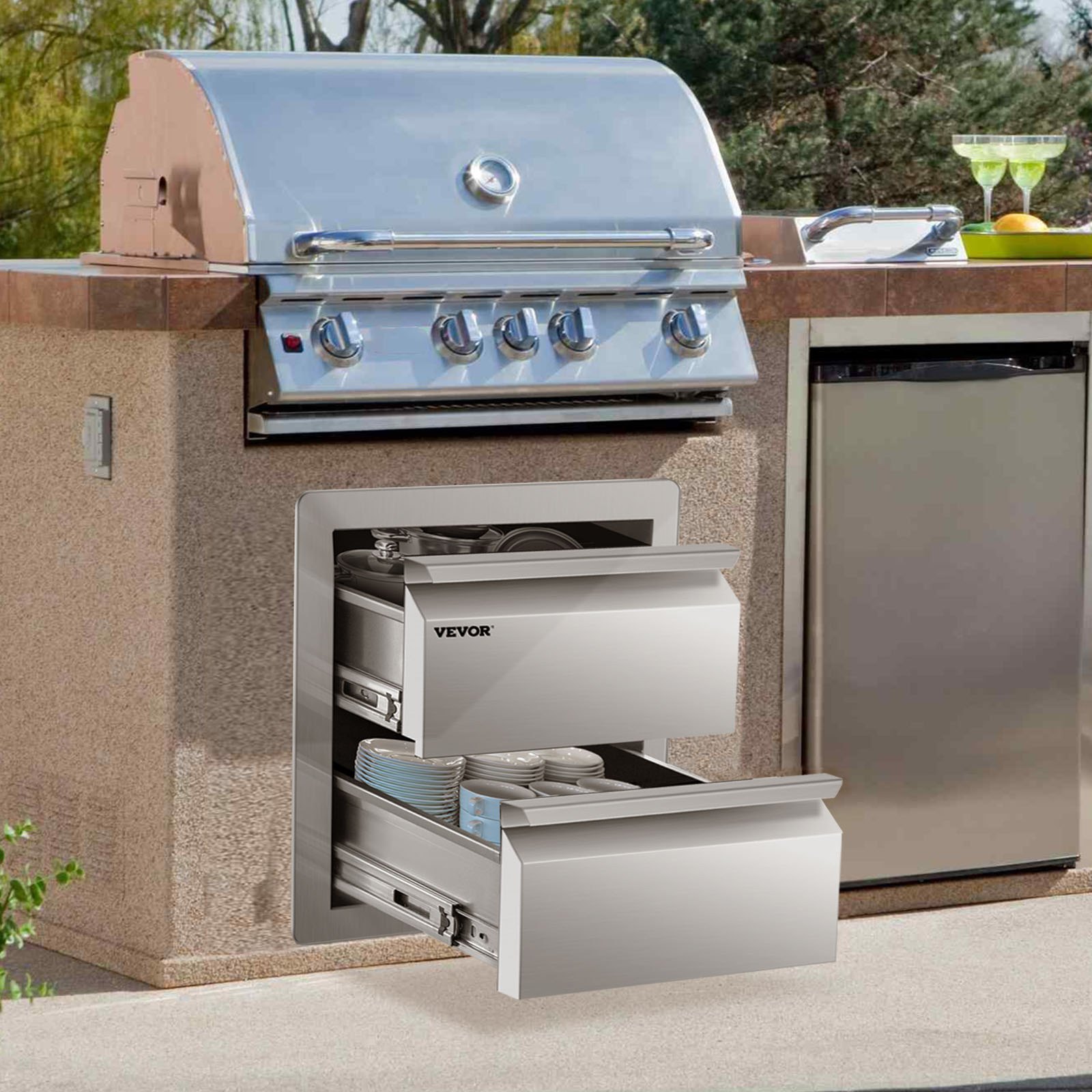 Cocina al aire libre con cajones de cocina al aire libre VEVOR, parrilla y refrigerador contra una encimera de piedra.