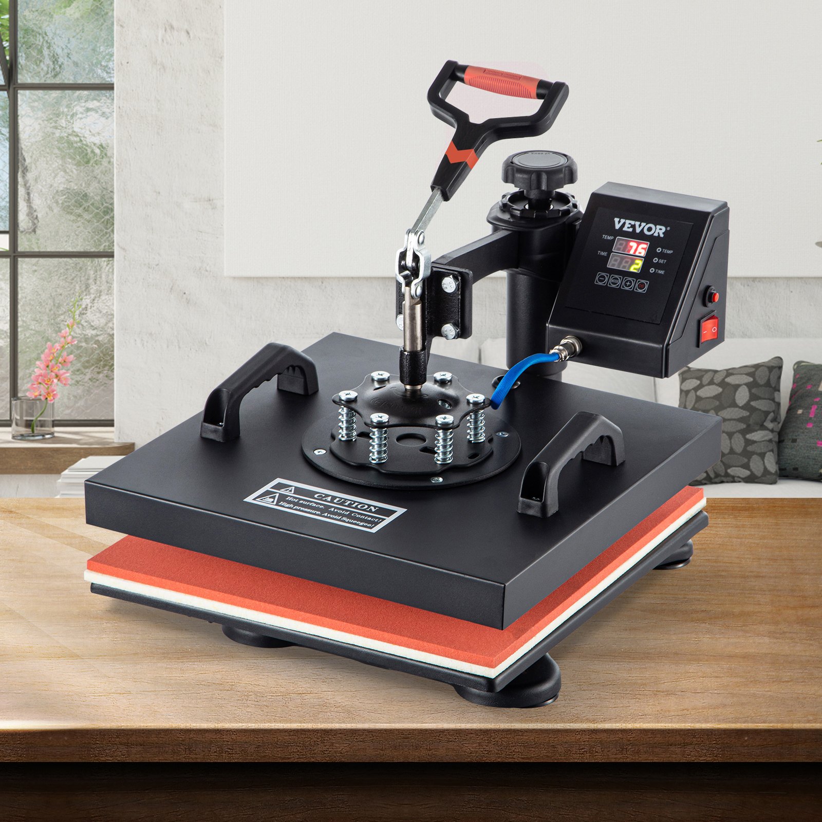 Máquina de prensado térmico VEVOR sobre una mesa de madera en una habitación luminosa y moderna.