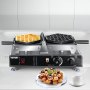 Máquina para hacer waffles con burbujas VEVOR en uso con waffles terminados y una taza de café al lado.
