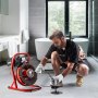 Hombre usando una máquina limpiadora de desagües VEVOR en un baño moderno con bañera independiente.