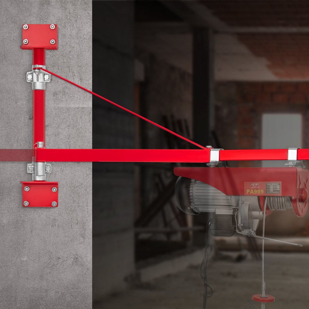 Brazo de elevación eléctrico VEVOR rojo montado en una pared de hormigón en un entorno industrial.