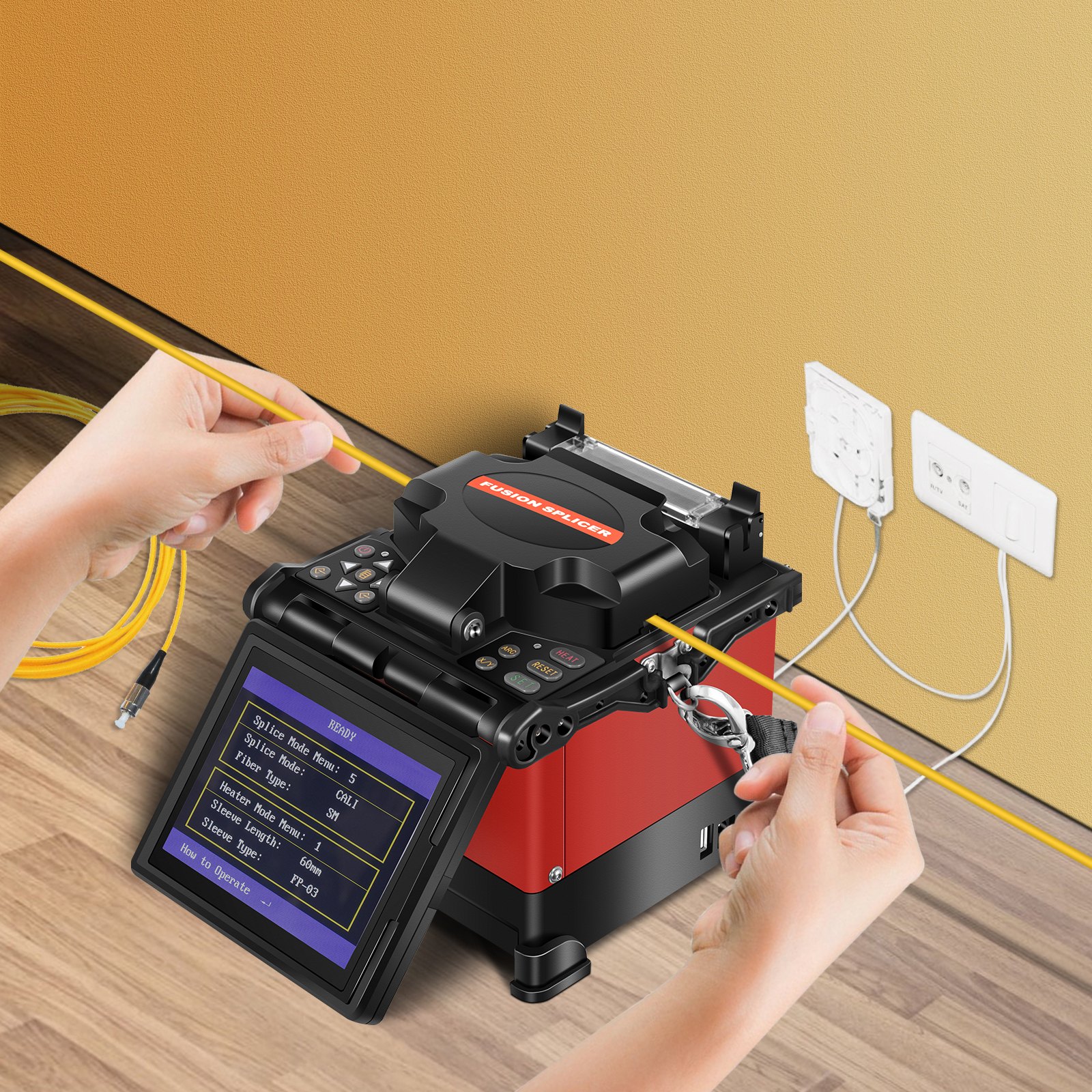 Manos operando el empalmador de fusión de fibra VEVOR cerca de tomas de pared y cables de fibra.