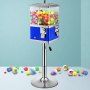 Máquina expendedora VEVOR con chicles y cápsulas de colores sobre un soporte cromado.