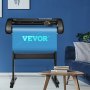 Máquina cortadora de vinilo VEVOR en una moderna oficina en casa con paredes azules y una acogedora zona de estar.