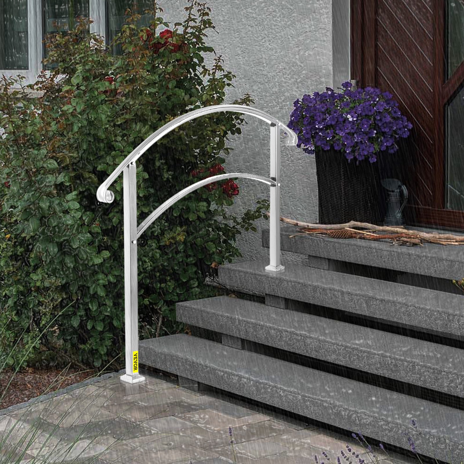 Pasamanos de exterior VEVOR en un día lluvioso junto a escalones de hormigón, con plantas y flores.