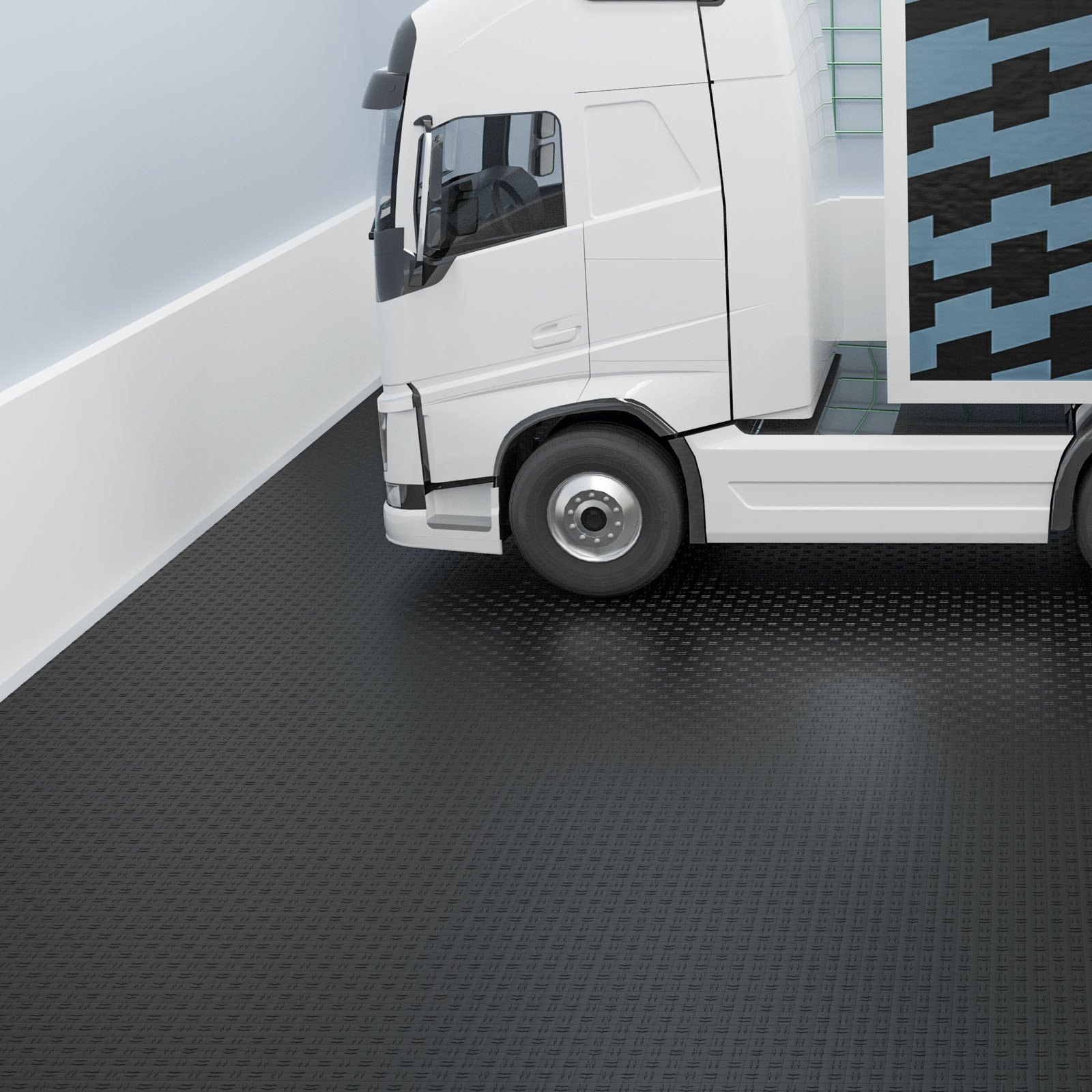 Camión blanco sobre un elegante piso de baldosas de garaje VEVOR de color negro junto a una superficie estampada en azul y negro.