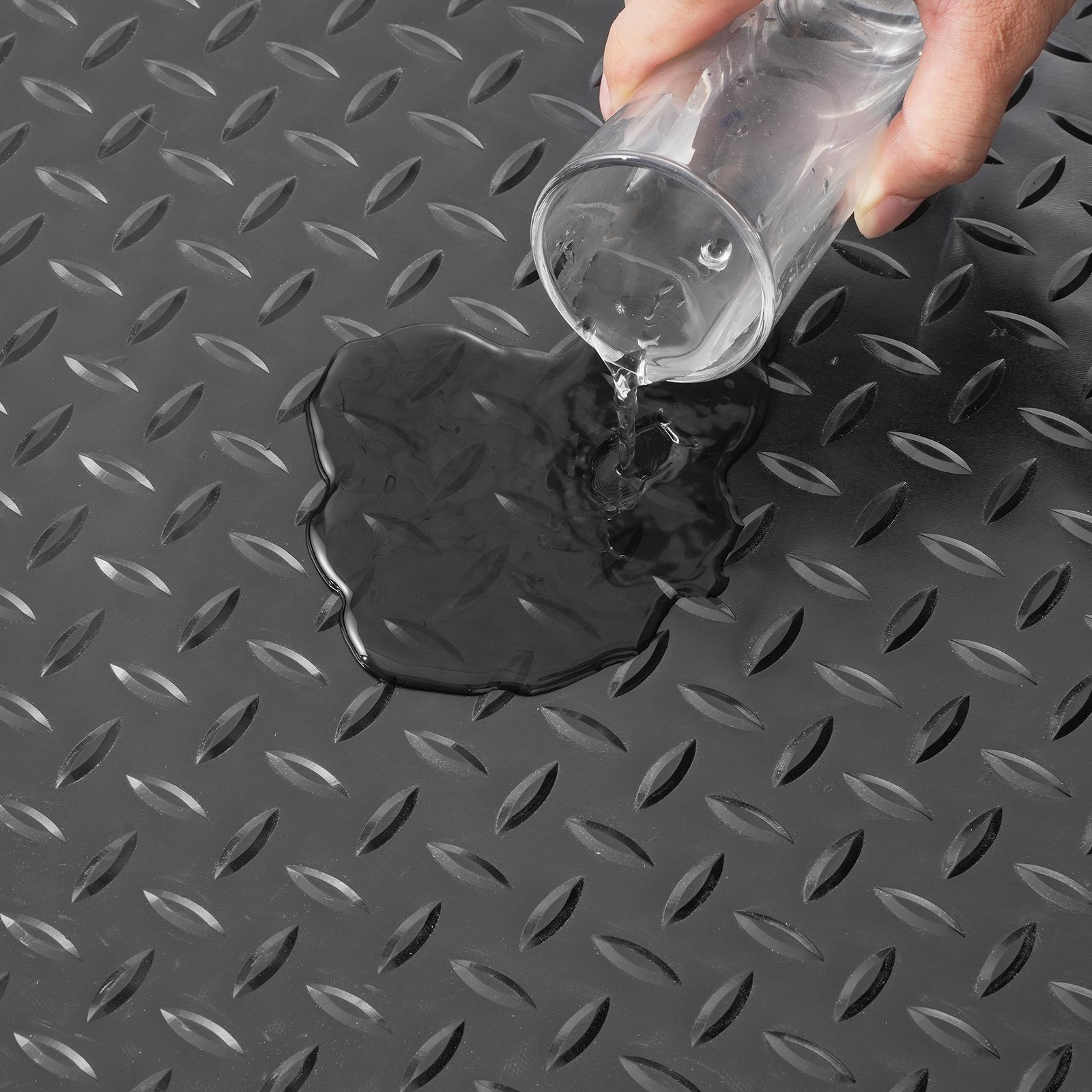 Derrame de agua sobre alfombrillas de garaje VEVOR con patrón de placa de diamante.