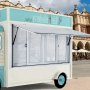 Camión de comida con ventana de concesión VEVOR estacionado cerca de un edificio histórico y una cafetería al aire libre.