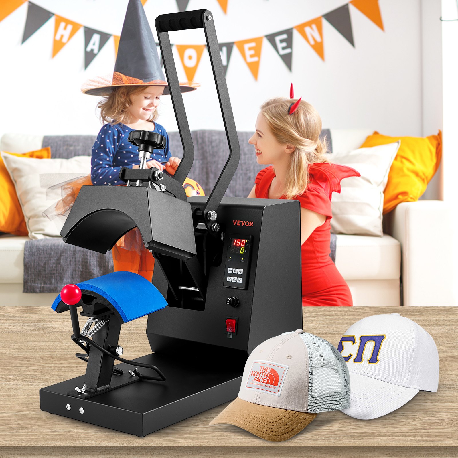 Prensa térmica de sombrero VEVOR sobre una mesa con decoración festiva de Halloween y niños disfrazados en el fondo.