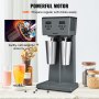 Potente batidora VEVOR con dos tazas de acero inoxidable junto a bebidas coloridas sobre una mesa.