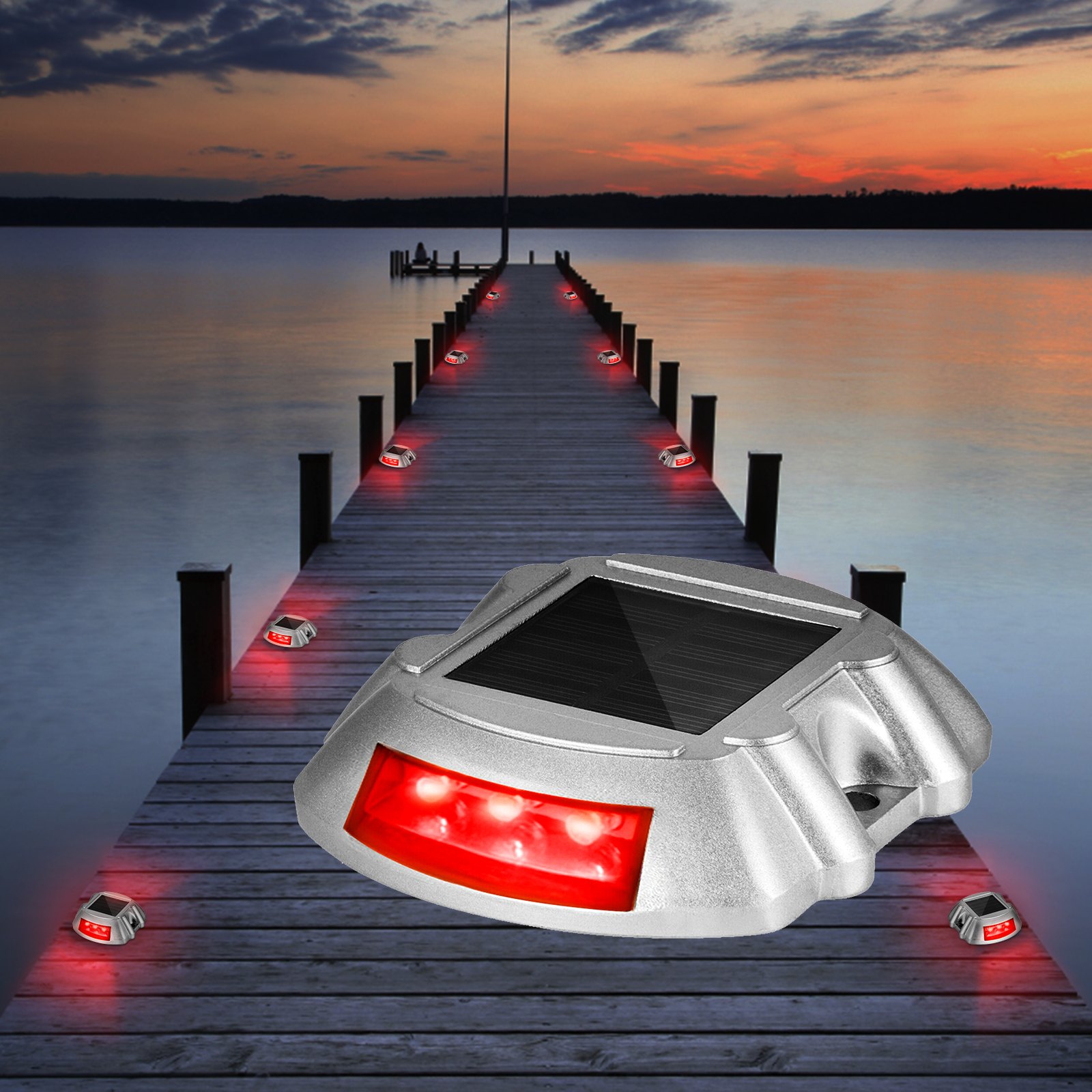 Luces de entrada solares VEVOR que iluminan un muelle de madera al atardecer con un brillo LED rojo.