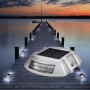 Luces de entrada solares VEVOR que iluminan un muelle de madera al atardecer, cerca de un lago tranquilo.