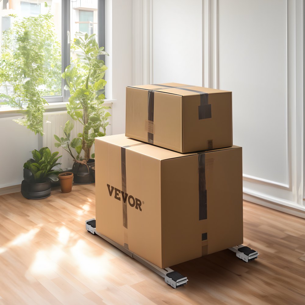 Cajas de cartón apiladas sobre rodillos para electrodomésticos VEVOR en una habitación soleada con plantas y suelo de madera.