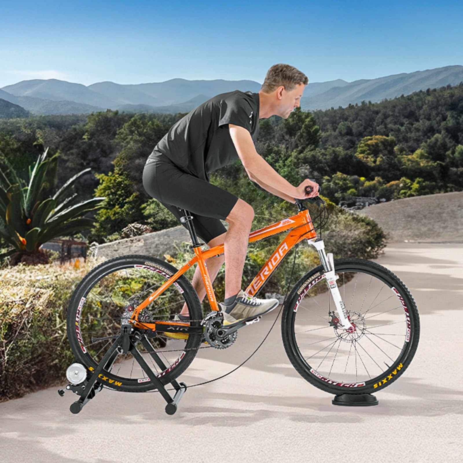 Ciclista que utiliza un soporte para bicicleta VEVOR al aire libre con un paisaje montañoso de fondo.