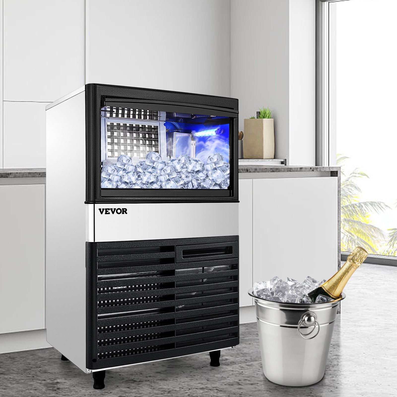 Máquina de hielo comercial VEVOR en una cocina moderna, cubo de hielo con champán cerca.