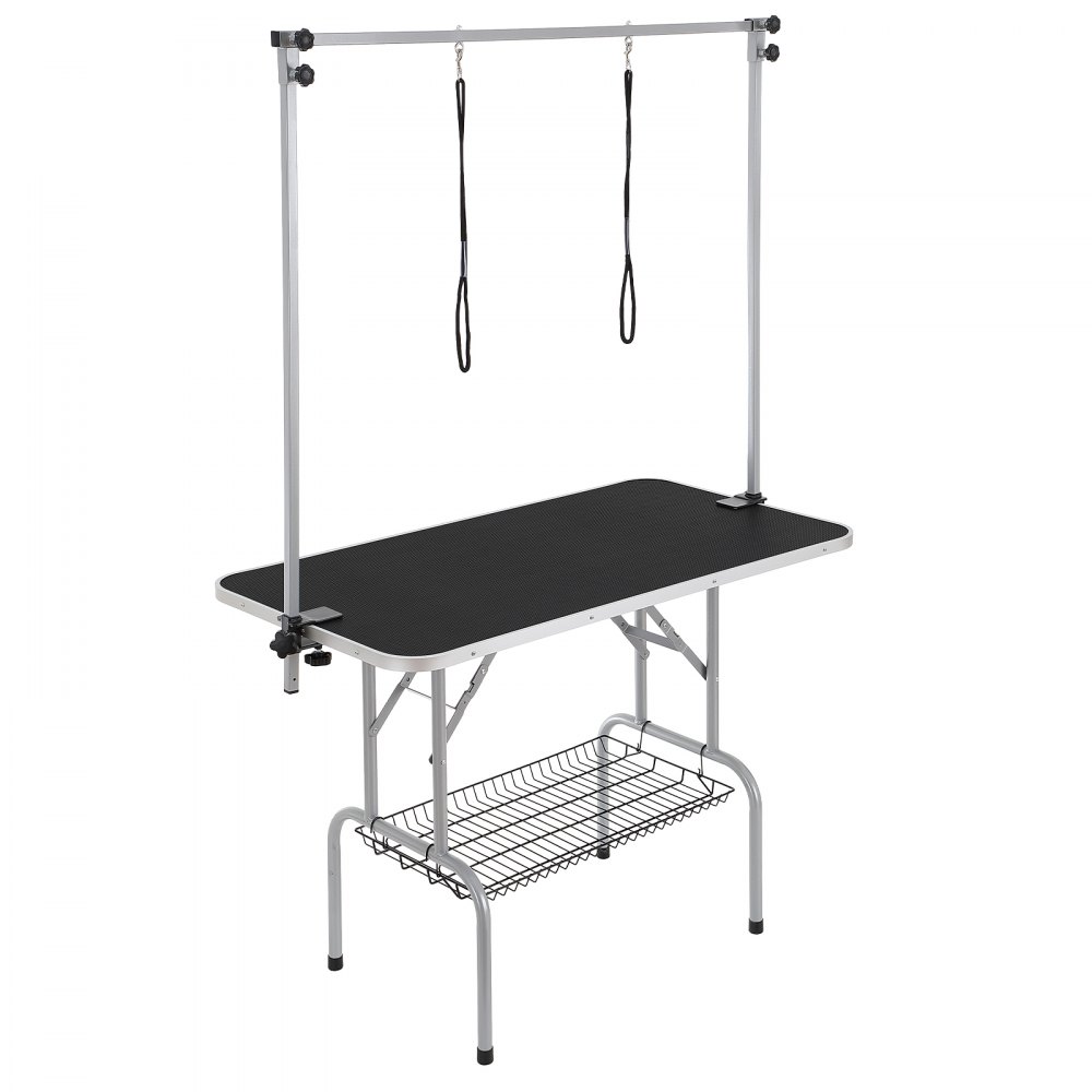 Mesa de aseo para mascotas VEVOR con brazo ajustable, superficie antideslizante negra y estante de almacenamiento.