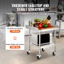 VEVOR stainless steel work table with thick tabletop, knife holder, vegetables, and microwave in a kitchen.