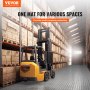 warehouse forklift on VEVOR garage tiles, with stacked boxes on shelves under a bright skylight.