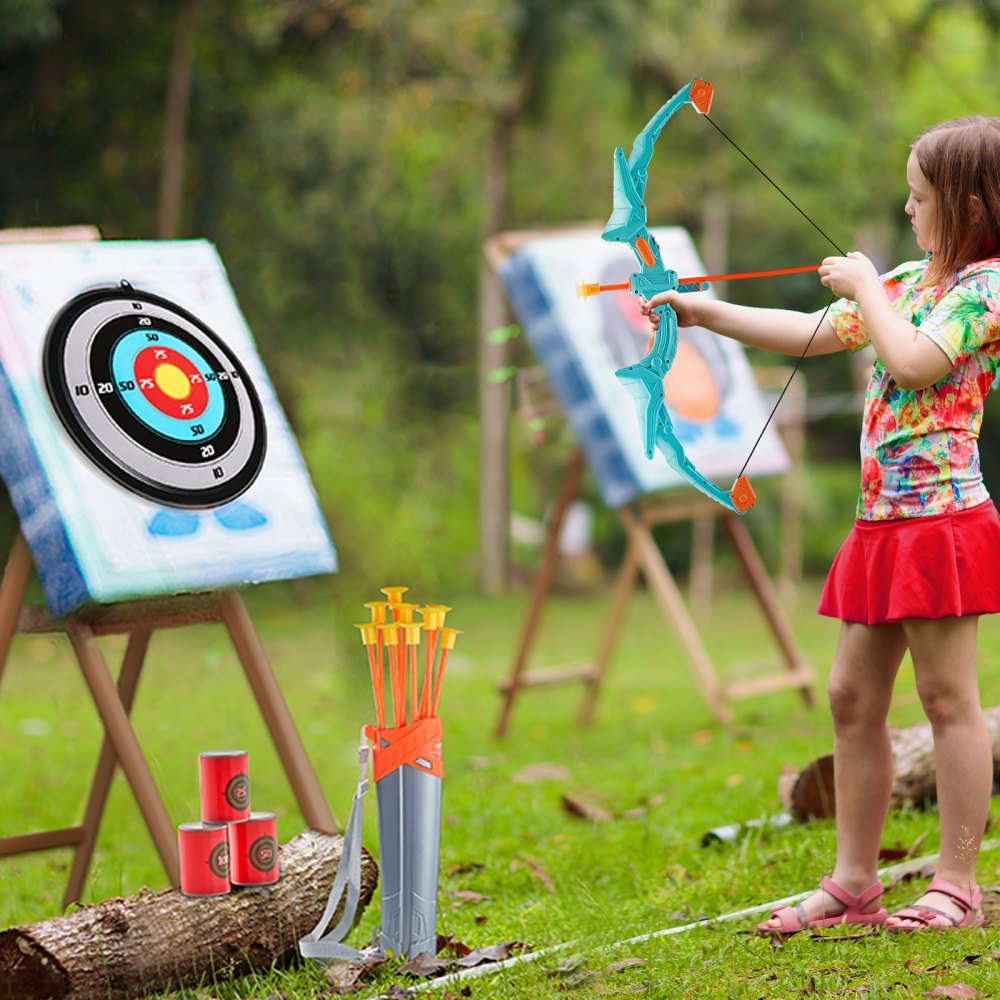 child playing with VEVOR kids archery set outdoors, aiming at target boards with arrows by her side.