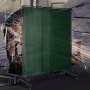 VEVOR welding screen protecting against sparks with welder working in the background.