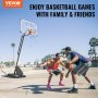 VEVOR basketball hoop; two players engaged in an outdoor basketball game on a sunny day.