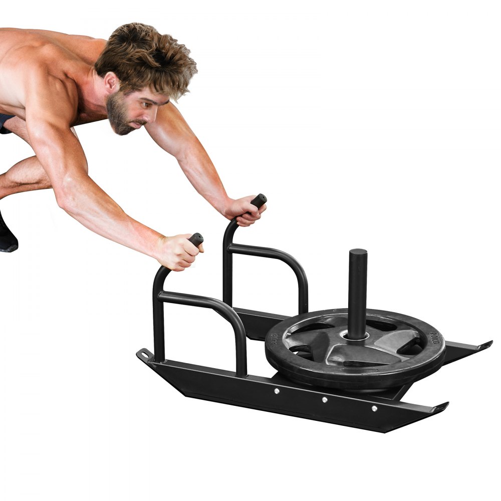 man pushing VEVOR weight training sled with plates, displaying muscle engagement and fitness strength.