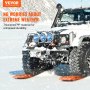 VEVOR traction boards under a snow-covered 4x4 vehicle in a snowy landscape, ensuring durability and stability.