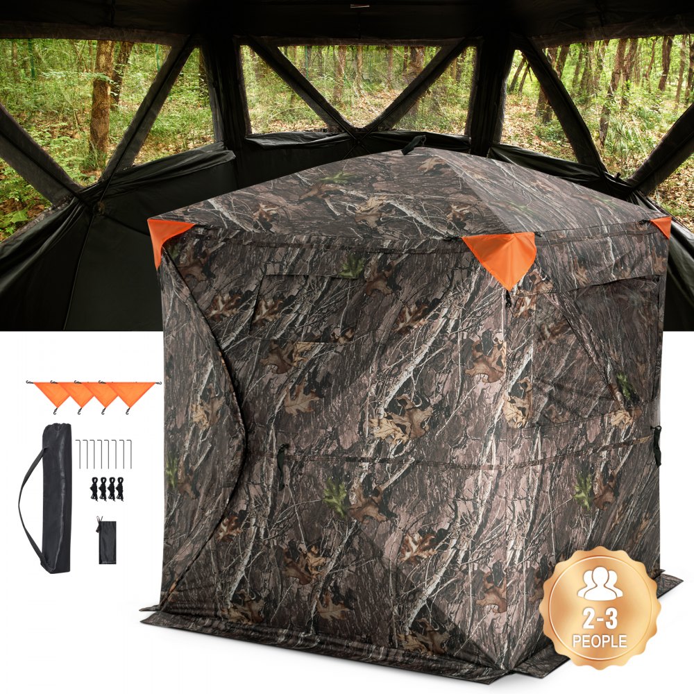 VEVOR hunting blind in forest with camo pattern, orange accents, setup accessories, and 2-3 people capacity.