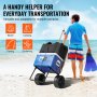 man pulling VEVOR beach dolly with cooler and gear on sandy beach, holding fins, blue sky background.