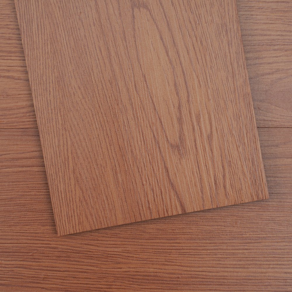 VEVOR vinyl floor tiles with a realistic wood grain pattern in warm brown tones.