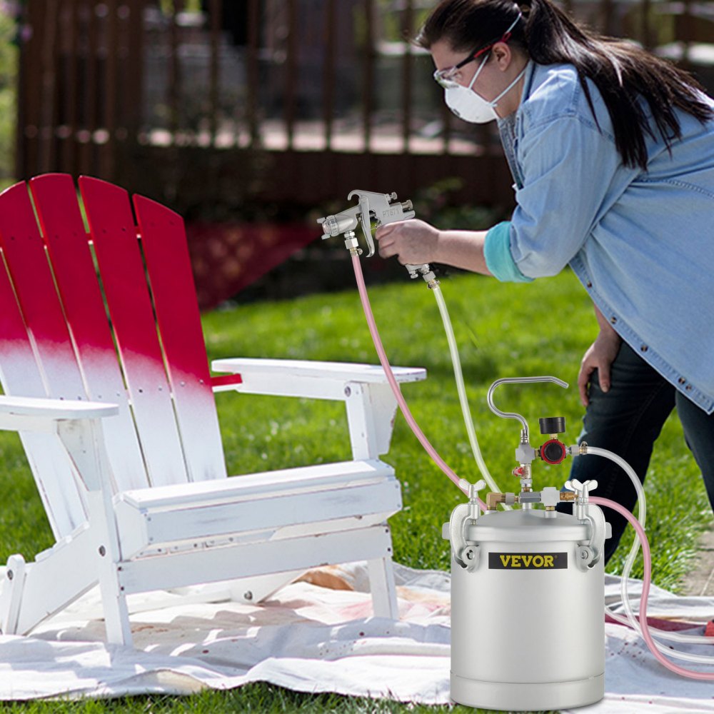painting a wooden chair with VEVOR paint tank in a garden setting.