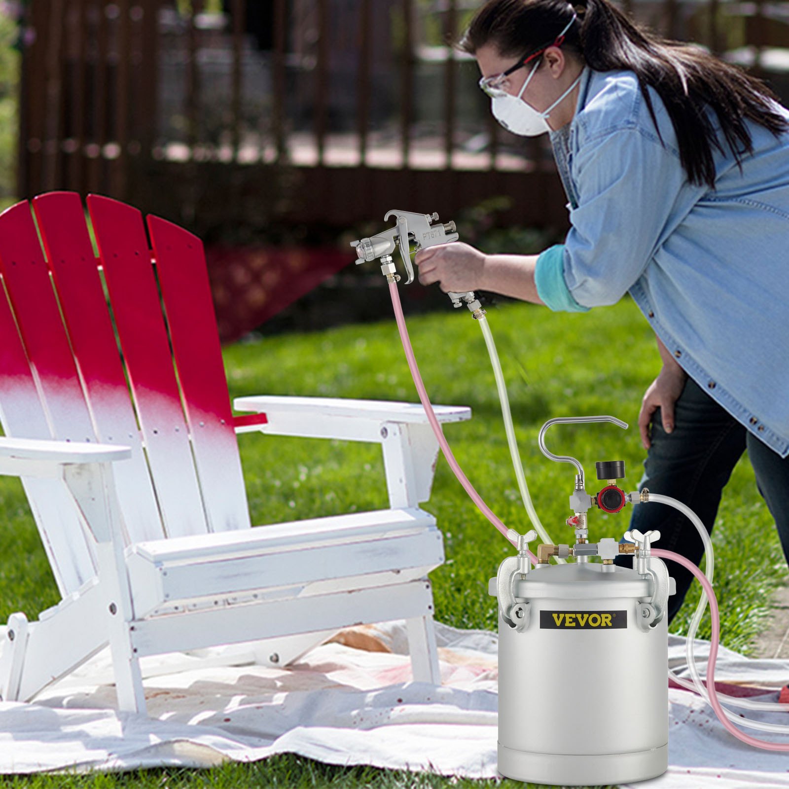 painting a wooden chair with VEVOR paint tank in a garden setting.