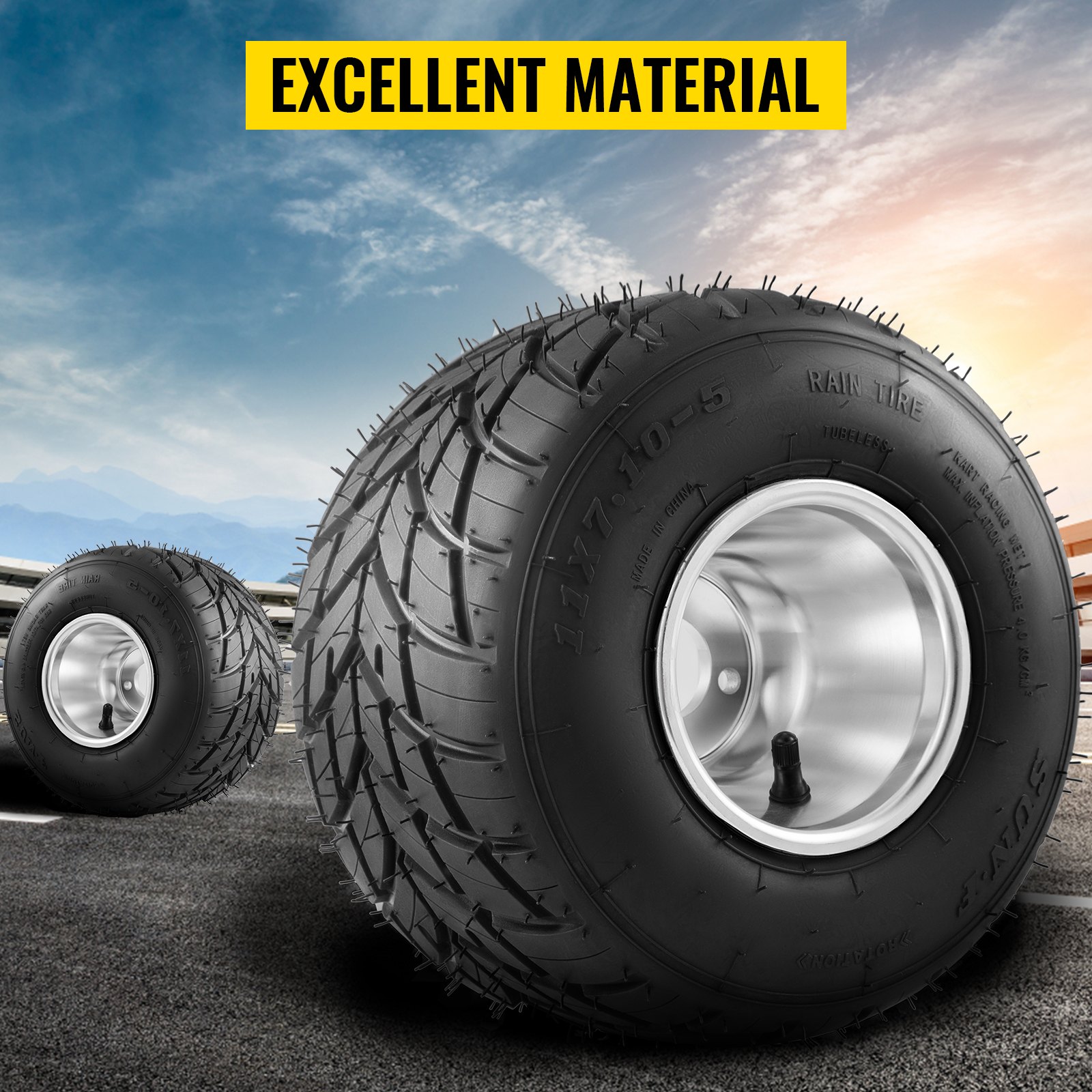 VEVOR go kart tires and rims on asphalt, with a blue sky and mountains in the background.