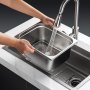 washing VEVOR hotel pan under faucet in modern kitchen sink with running water.