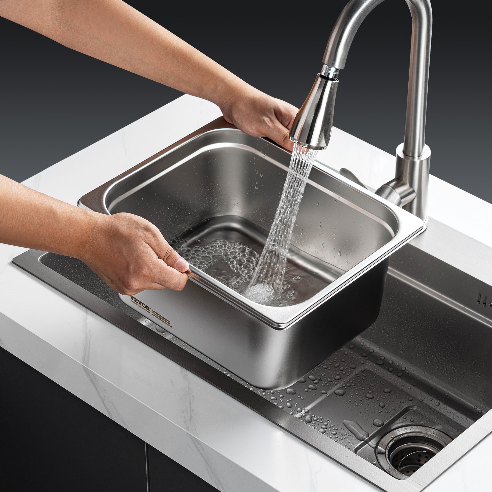 washing VEVOR hotel pan under faucet in modern kitchen sink with running water.