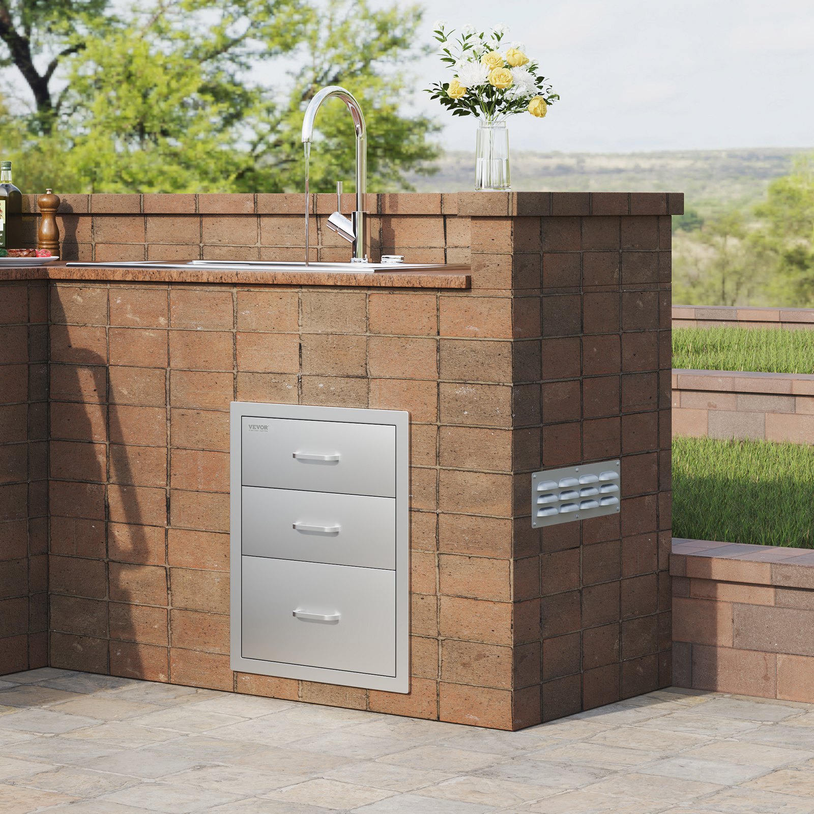 outdoor kitchen with VEVOR bbq drawers, stainless steel sink, and lush green backdrop.