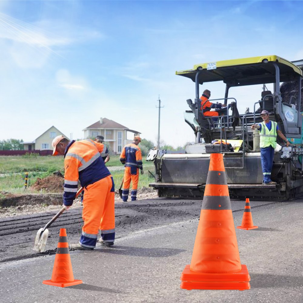 construction workers and machinery behind VEVOR safety cones on a roadwork site under a clear sky.