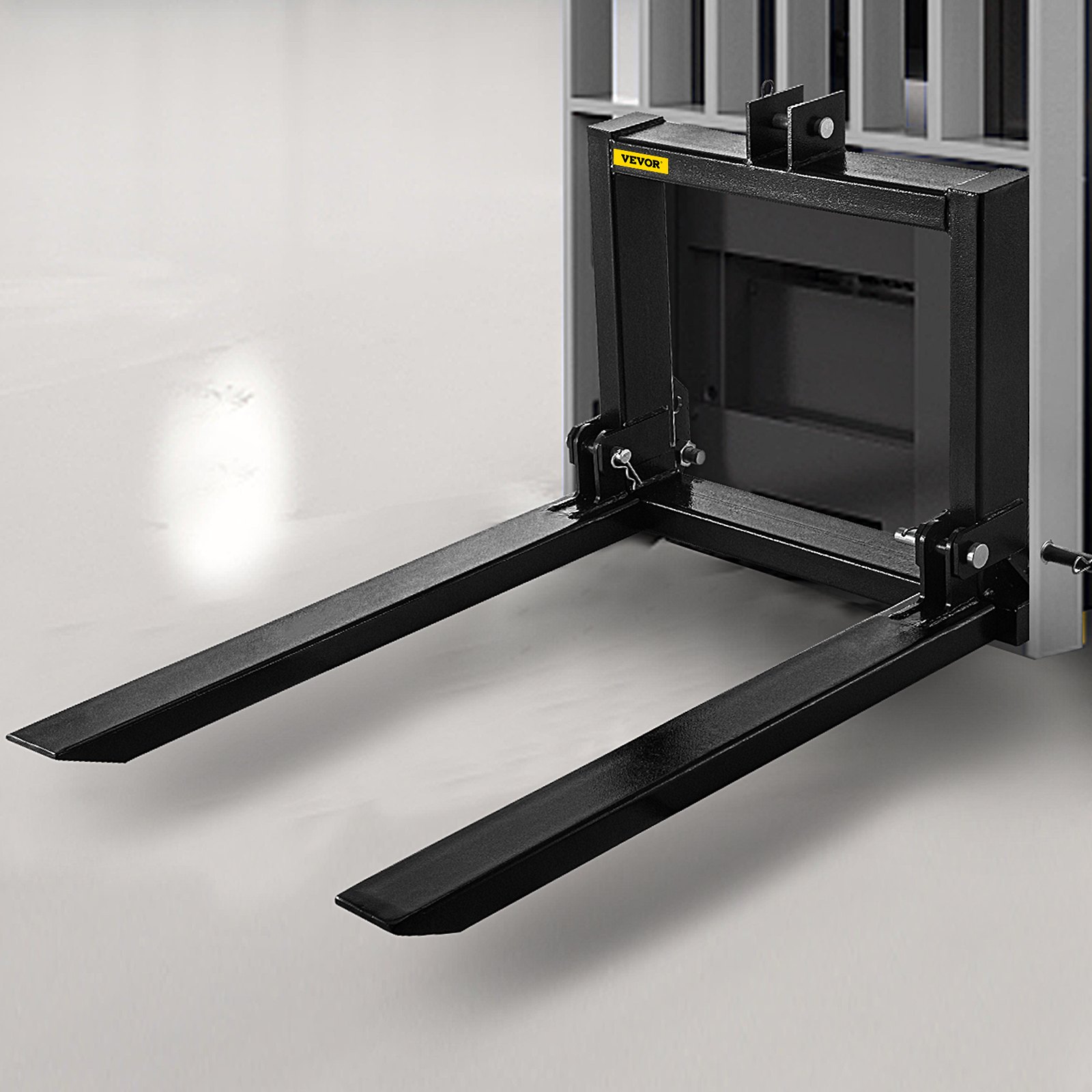 VEVOR 3 point hitch pallet fork on a smooth floor, ready for heavy lifting.