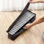 hands placing a VEVOR glockenspiel xylophone into a black carrying case on a wooden floor.
