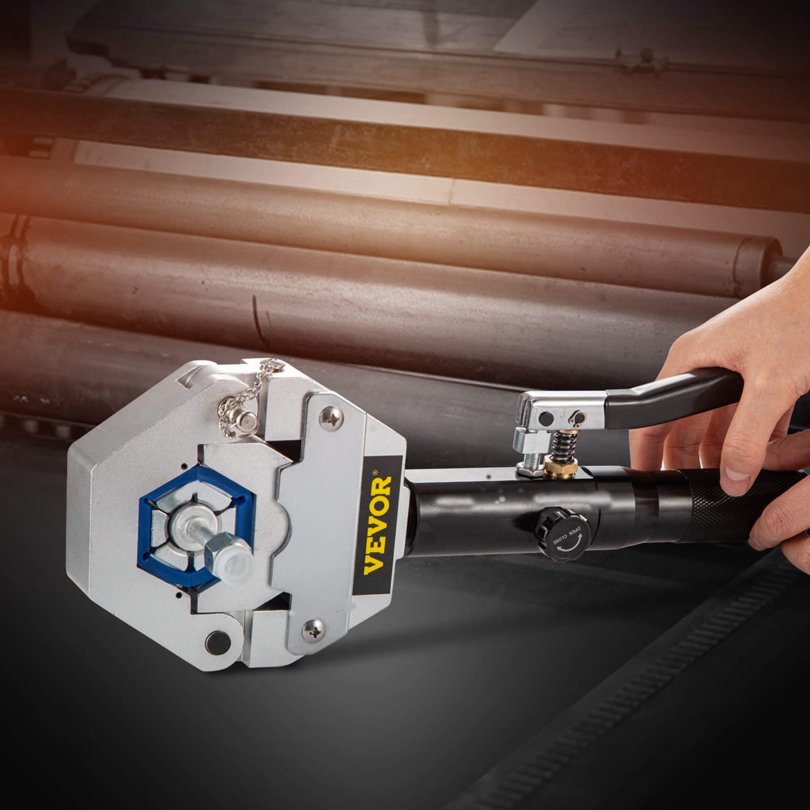 VEVOR hydraulic hose crimper in use, with industrial rollers in the background.