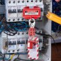 electrical panel secured with VEVOR lockout tagout kits for safety, showing warning tags and padlocks.