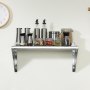 VEVOR stainless steel shelf in kitchen with spice jars and containers, under a clock.