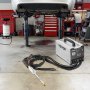 VEVOR dent puller displayed in an auto repair shop with car lift and red tool cabinets.